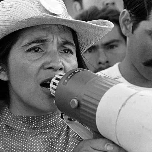 actress wearing a cowboy hat; speaking into megaphone