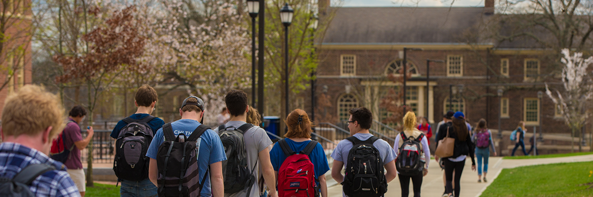 Students near Armstrong Center walk toward MacMillan Hall