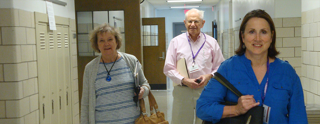 A group of retirees walk through the hallway before their class