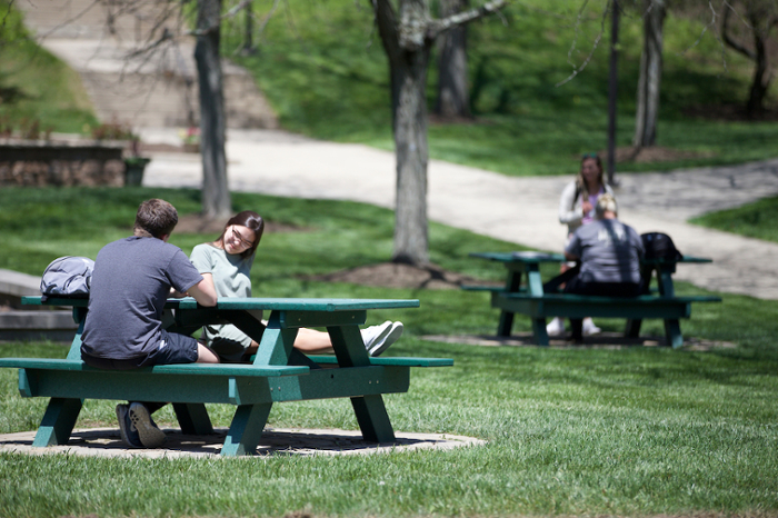 students on Middletown campus sit together at picnic tables