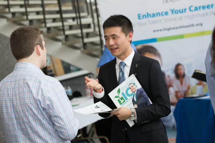 Student interviewing with prospective employer at career fair