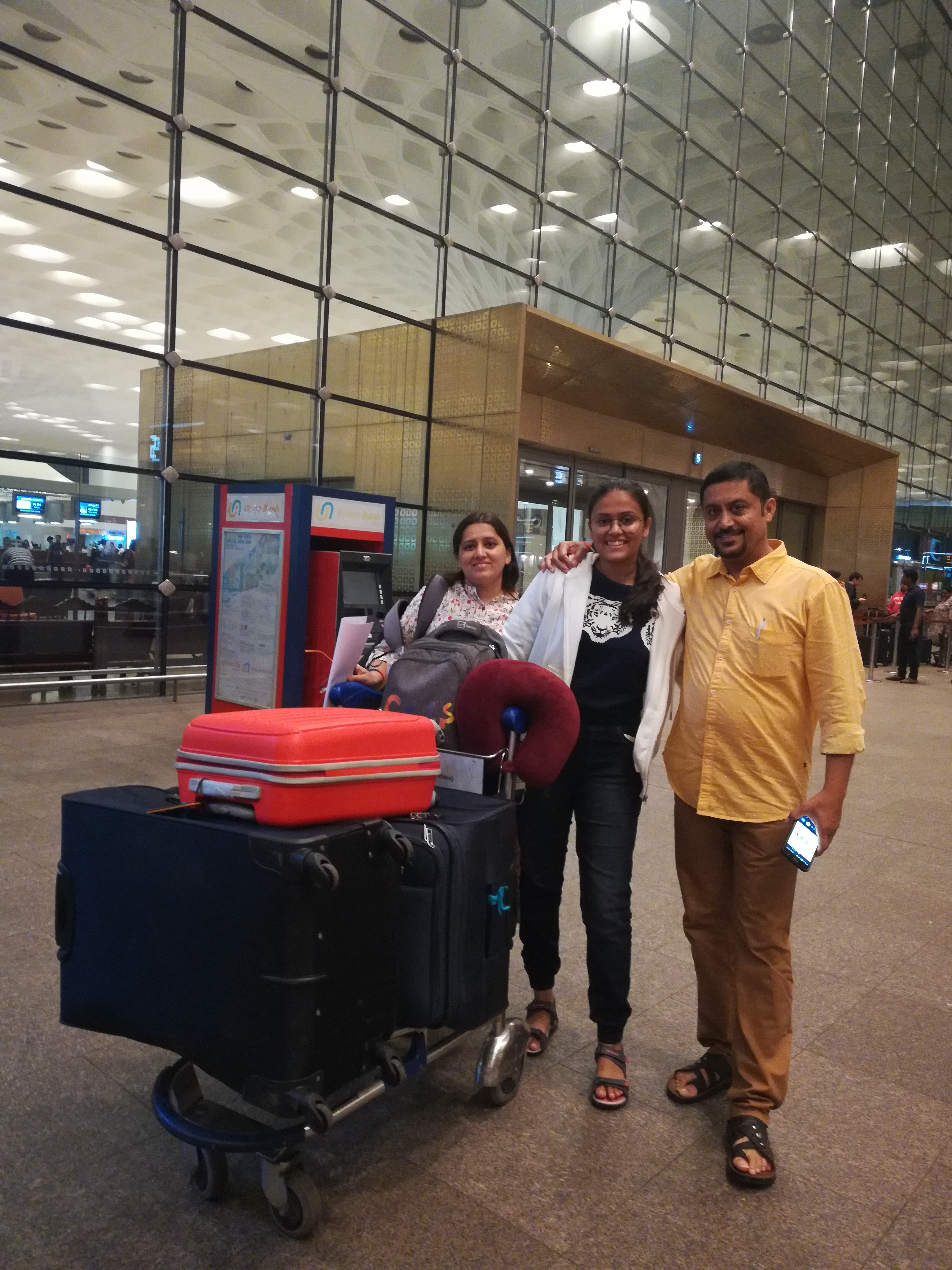 Sakshi with her parents at the airport in India before departing for school