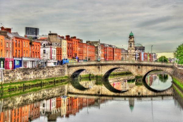 a bridge across a river next to some buildings in Dublin