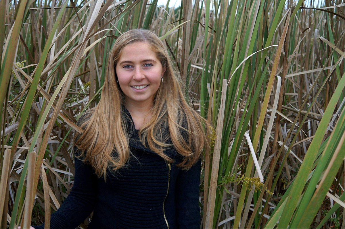 Grace in a field of grasses in Belize