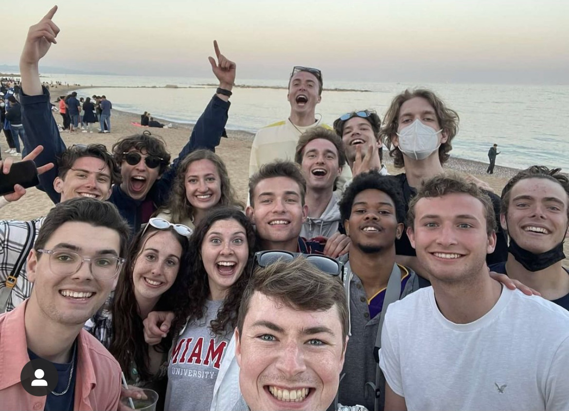 Smiling group of students on the beach