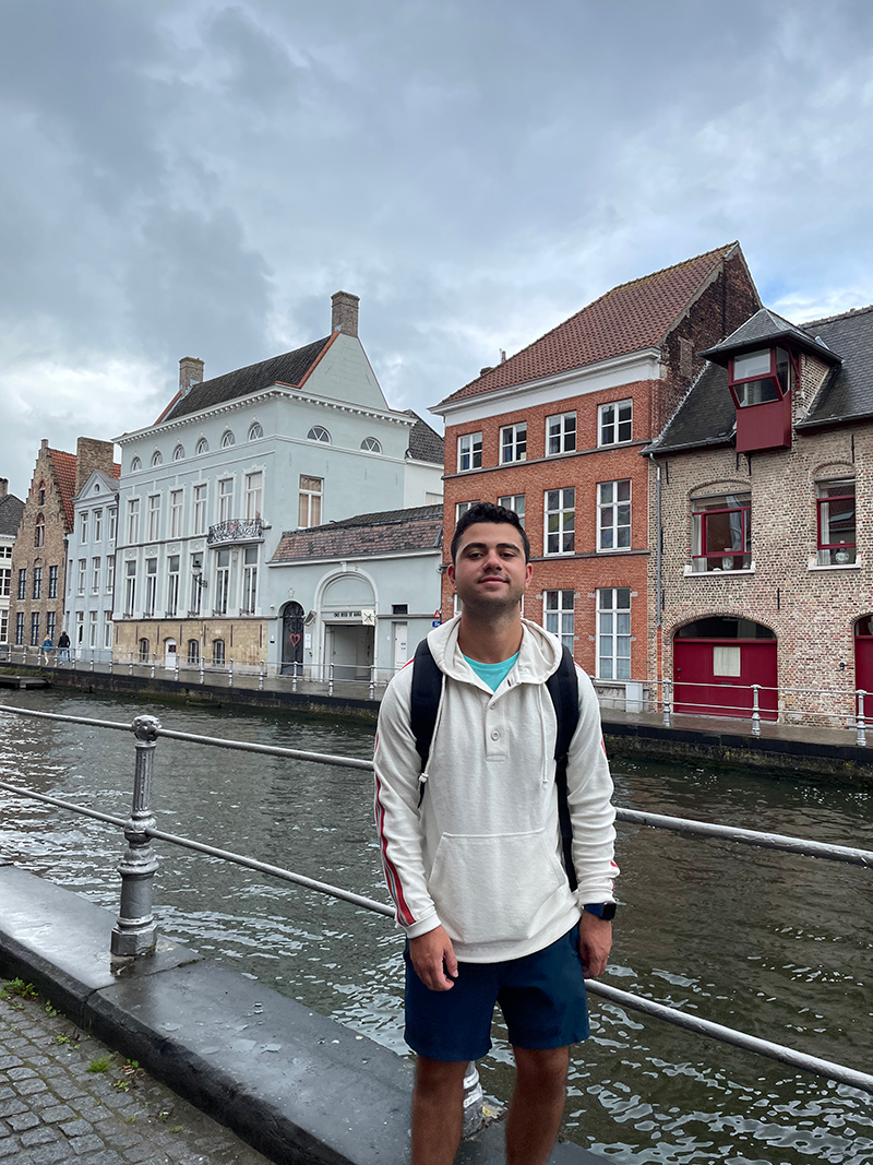 Max poses near a canal in Europe