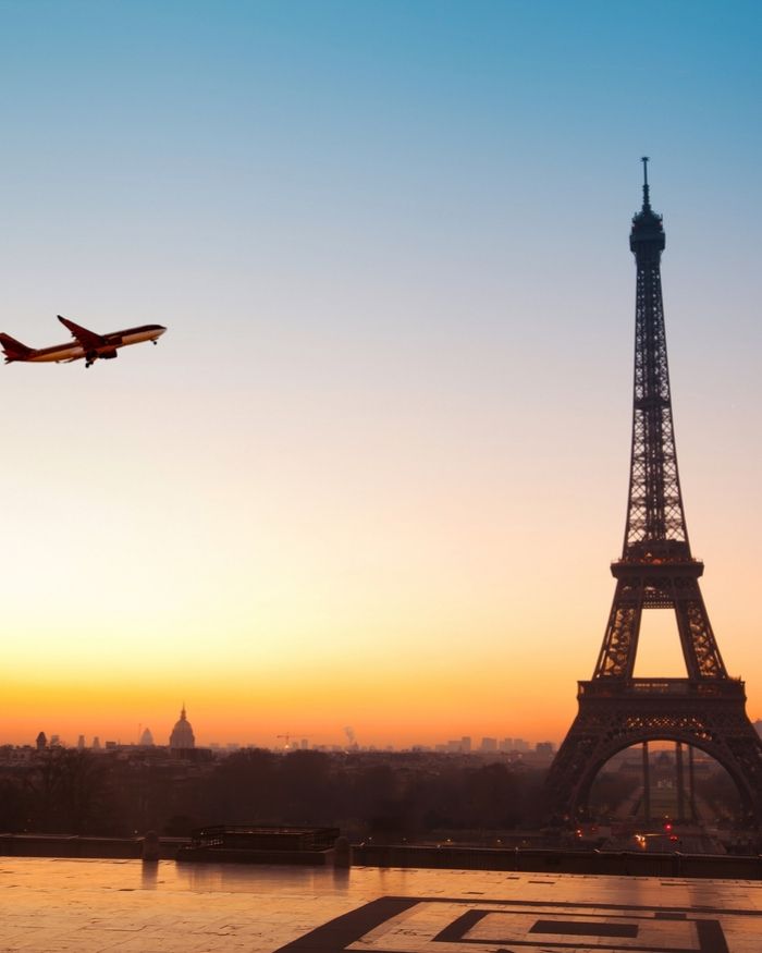 plane flying in Paris near Eiffel Tower