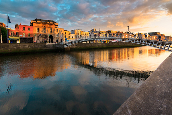 Sunset view of river, town, and bridge in Dublin