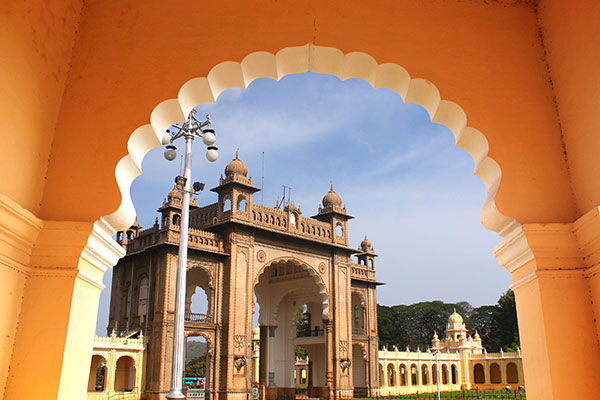 Architecturally beautiful building seen from a scalloped archway in India