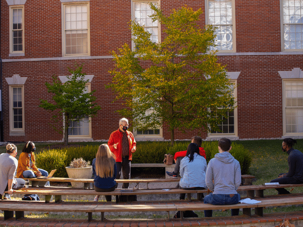 faculty member speaking with class outside