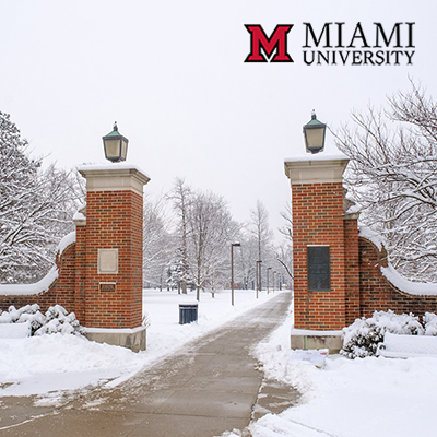 Full color logo over an image of a snow covered campus