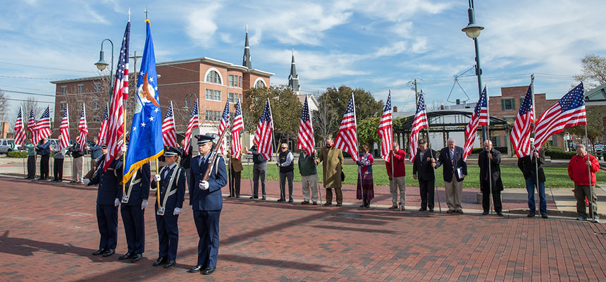 A military color guard at a Veterans Day celebration uptown