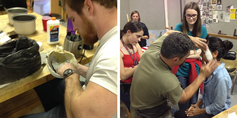 A student working on building his paper cast. The professor putting a paper cast on the side of a students face.