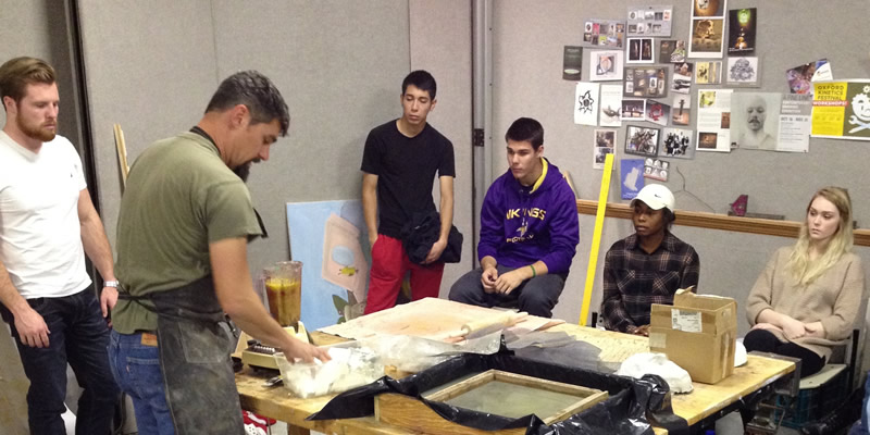 The professor talking about how to make the paper cast.