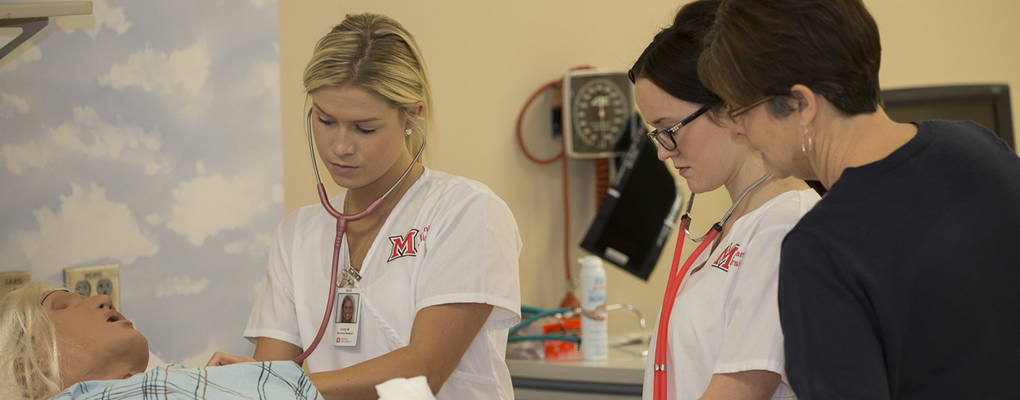 Nursing students working on a sim