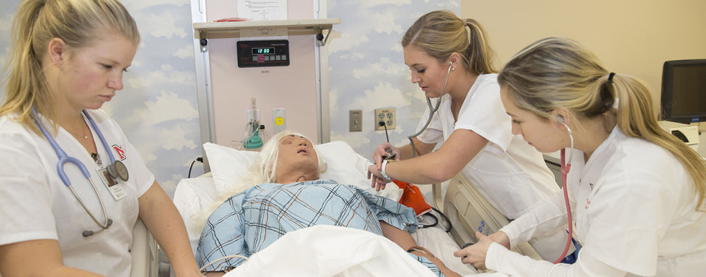 Nursing students working on a sim