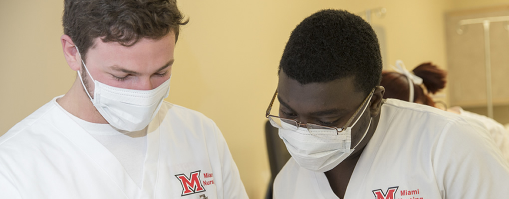 Male nursing students working together