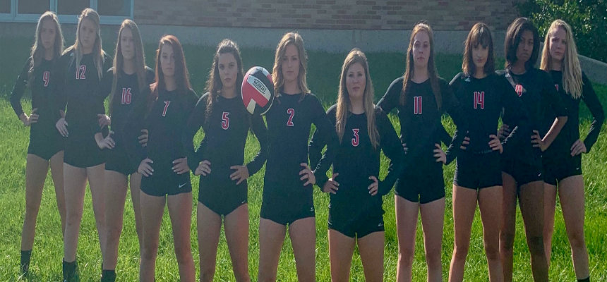 2018 Harrier Volleyball team standing under neath the archway at the Hamilton Campus