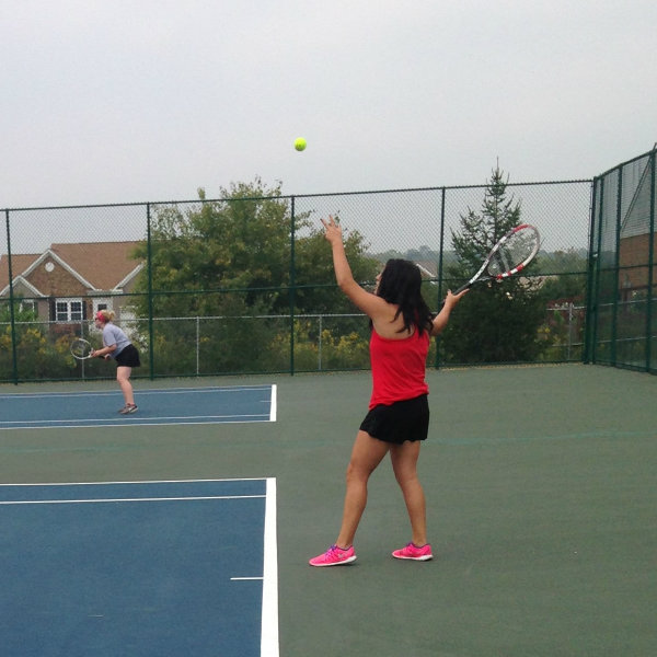 Women's tennis athlete serving