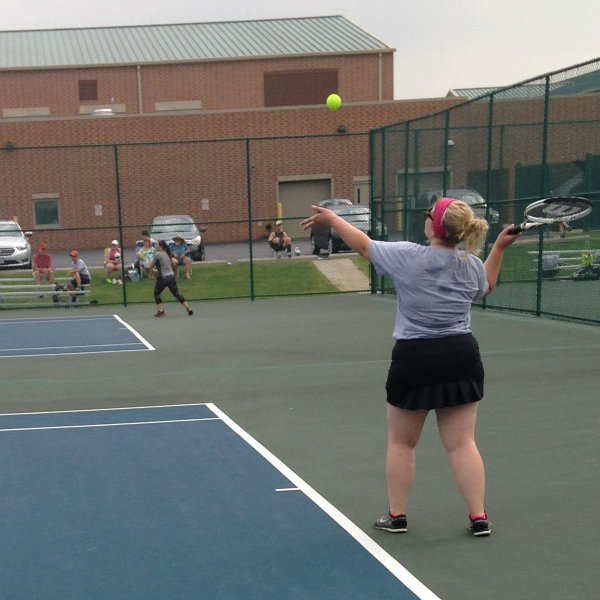 Women's team athlete serving