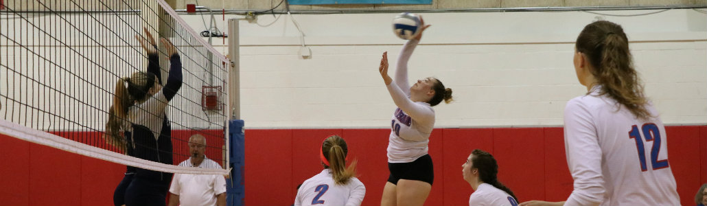 Miami Middletown volleyball team spiking the ball