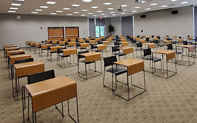 A classroom with desks that are 6 feet apart from one another.