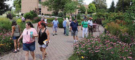 People walking around the formals gardens outside of the conservatory