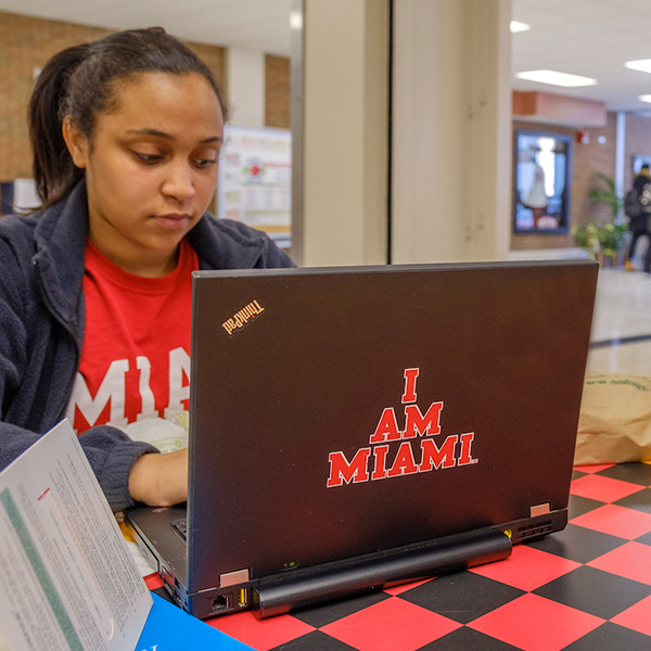 A Miami student working on her computer