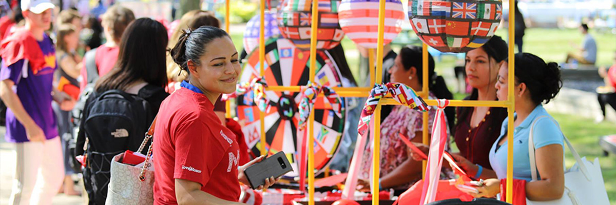  A student visiting a booth with international flags during Fall Fest in on the Middletown Campus. 