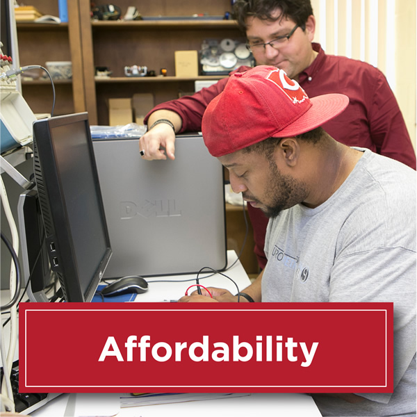 Photo of students working on on a computer and the professor looking over his shoulder helping him. Text reads Affordability with a red box and white text