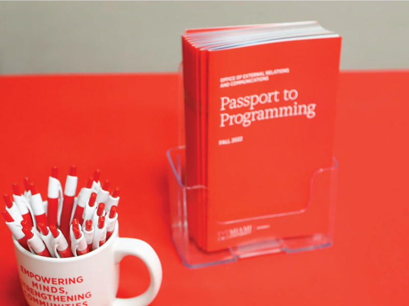 Passport to Programming book and a coffee mug with red pens