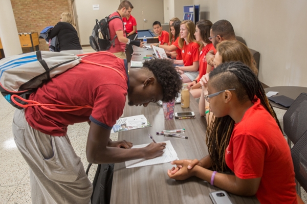 Student signing in to residence hall on move in day.