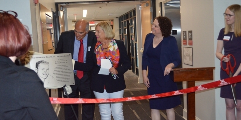 Bernie and Gloria Rinella, with VP for Student Life Jayne Brownell, unveiling the Rinella Nameplace at the Ribbon Cutting.