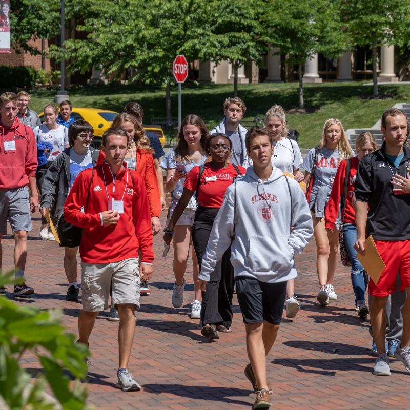 Large group of Miami students walking across campus at Orientation