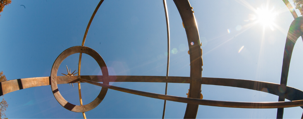 Close up image of sundial with bright blue sky background