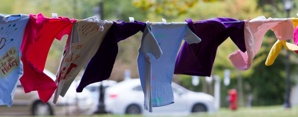 Shirts hanging from 2015 Clothesline Project
