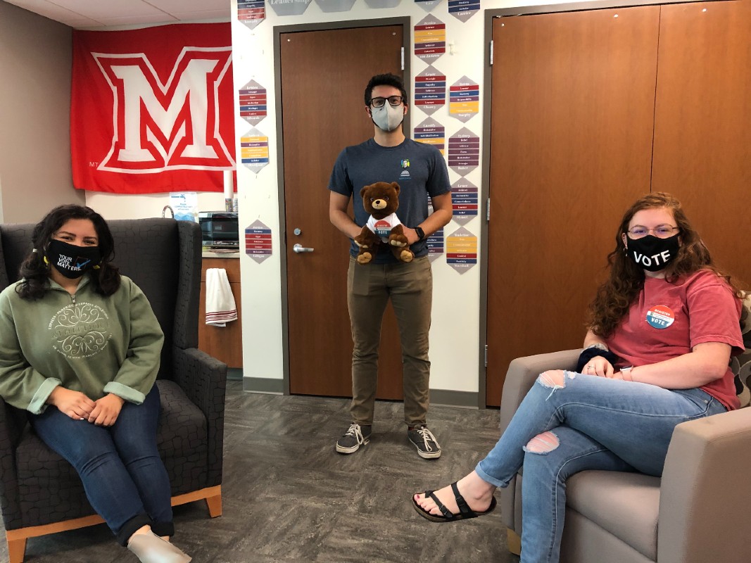 Civic Engagement student org leadership wearing "vote!" masks