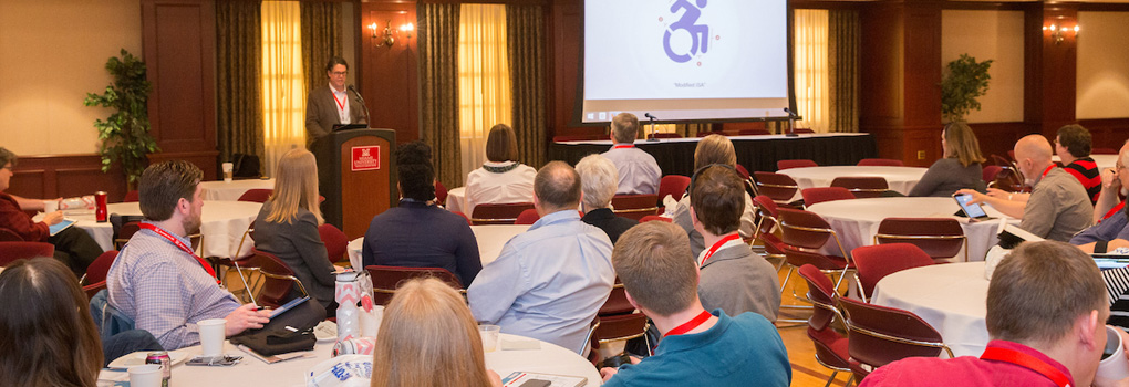 Guest speaker, Ken Petry, speaks at a past Access MU symposium to a large audience