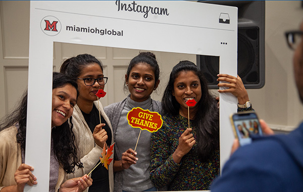 Group of international students with Instagram frame getting photo taken
