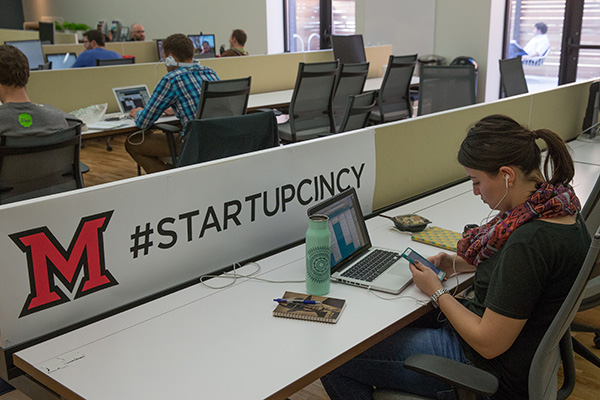 Student sitting in a table at a startup lab in Cincinnati