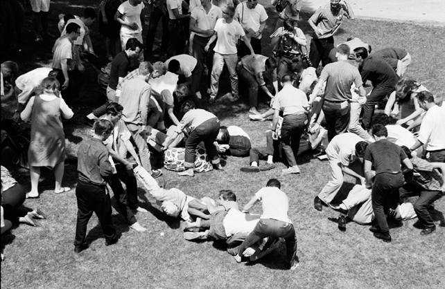 Freedom Summer Trainees curled up on the ground practicing non-violent resistance