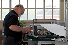 man making the paper for the great seal essay book