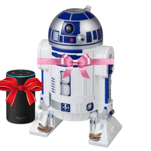 An Amazon Echo with a red bow next to a toy R2-D2 with a pink bow