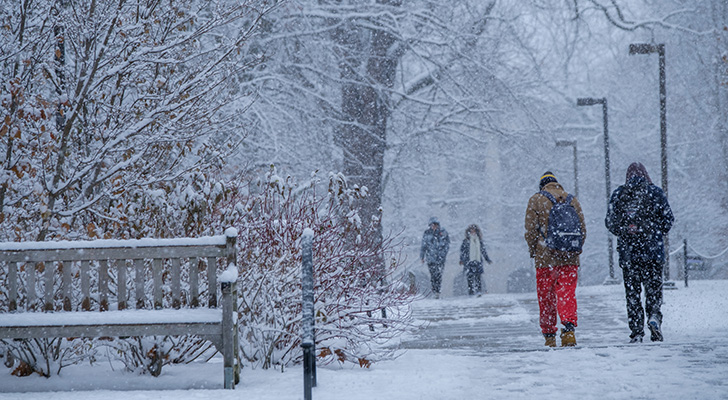 Students walk through a snowstorm at Miami University