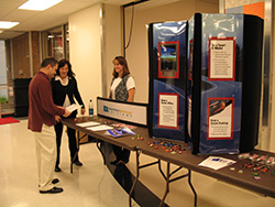 People standing at the security awareness table in 2006