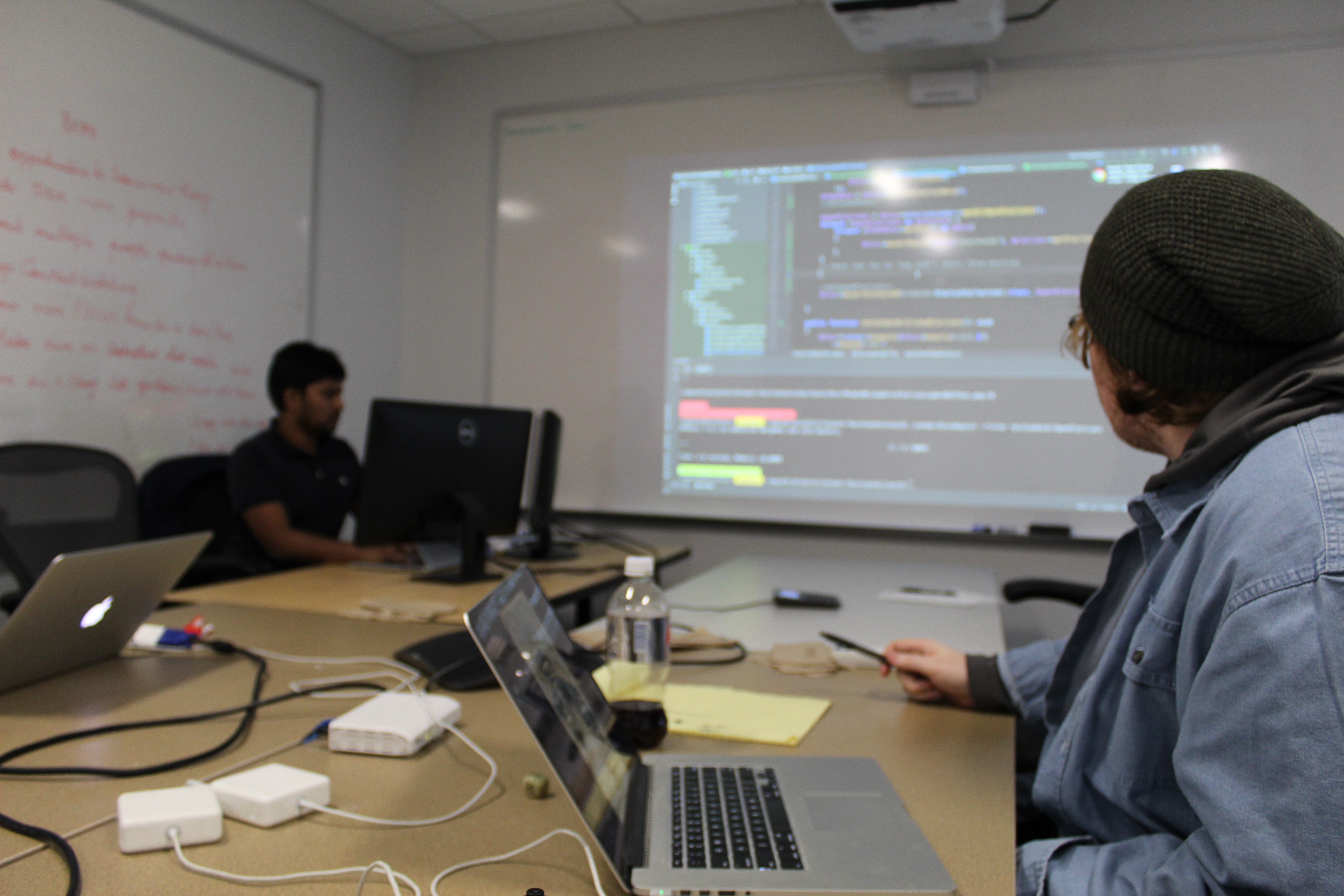 Developers looking at a screen of code