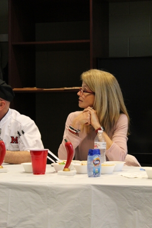 Dr Renate Crawford sitting at a table with a white cloth