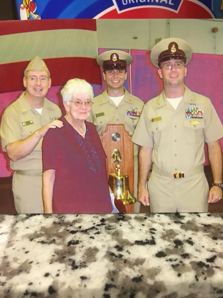John Virden stands with two other Naval members and an elderly person