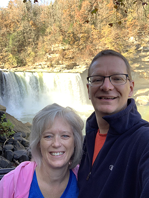 Dan Johnson and his wife Sue take a selfie in front of a waterfall