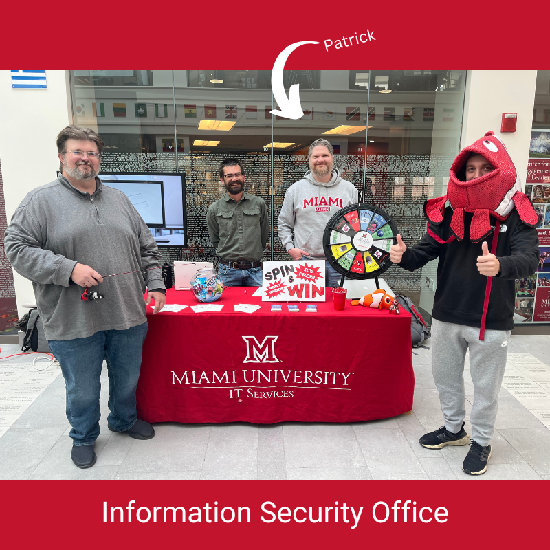 The information security office folks standing in front of our security awareness booth in Armstrong Student Center. One of them holds a fishing polee and one is wearing the "phish" head costume